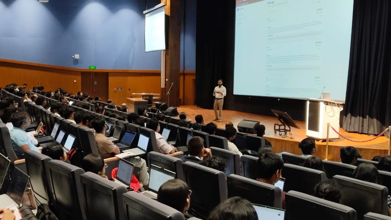 Bittoo lecturing in a packed campus auditorium